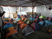 Asylum seekers wait for appointments through the CBP One app to apply for asylum in the United States in a shelter for migrants, Saturday, Feb. 3, 2024, in Tijuana, Mexico.