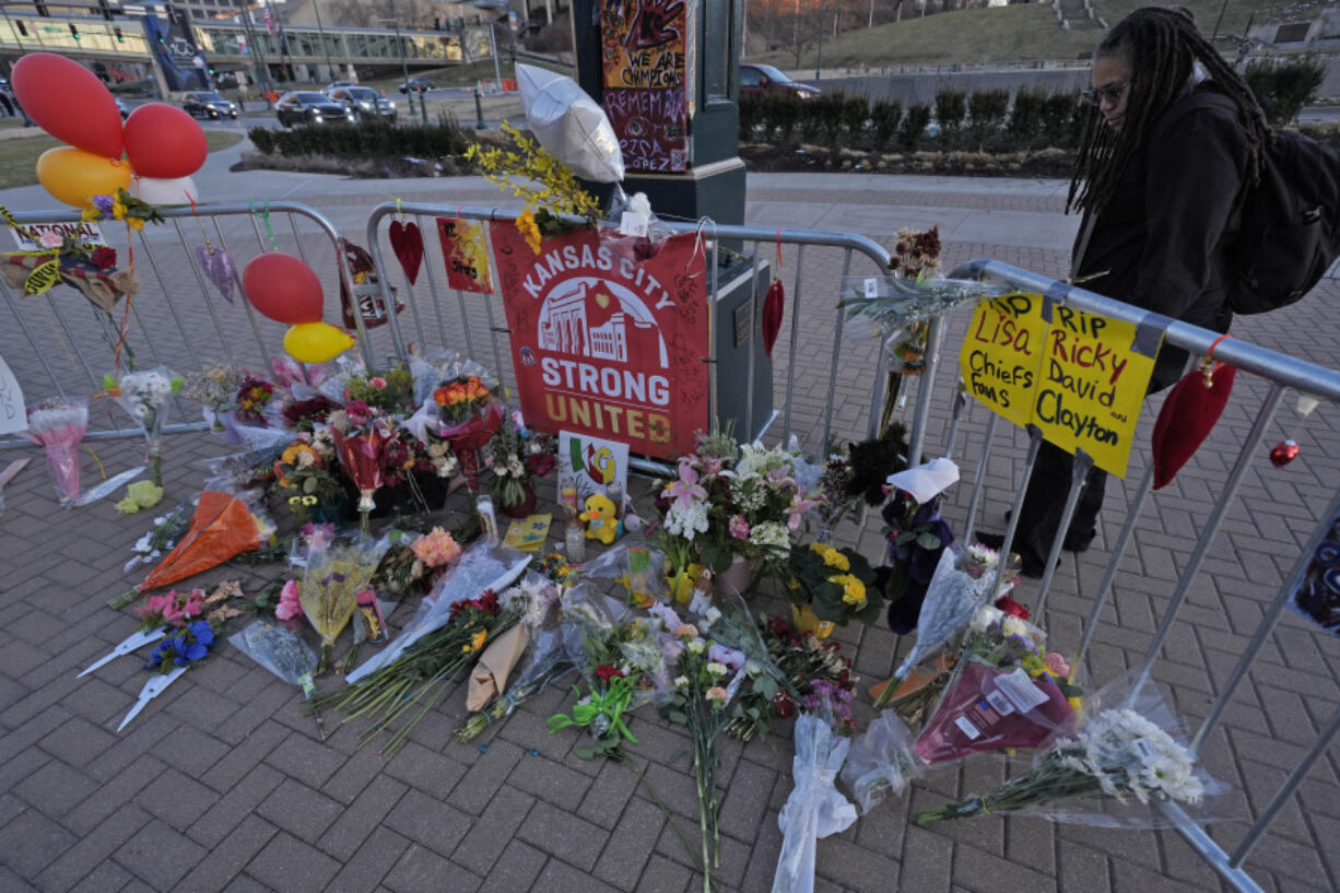 FILE - A person views a memorial dedicated to the victims of last week&rsquo;s mass shooting in front of Union Station, Sunday, Feb. 18, 2024, in Kansas City, Mo. Missouri prosecutors said Tuesday, Feb. 20, that two men have been charged with murder in last week&rsquo;s shooting that killed one person and injured multiple others after the Kansas City Chiefs&rsquo; Super Bowl parade.