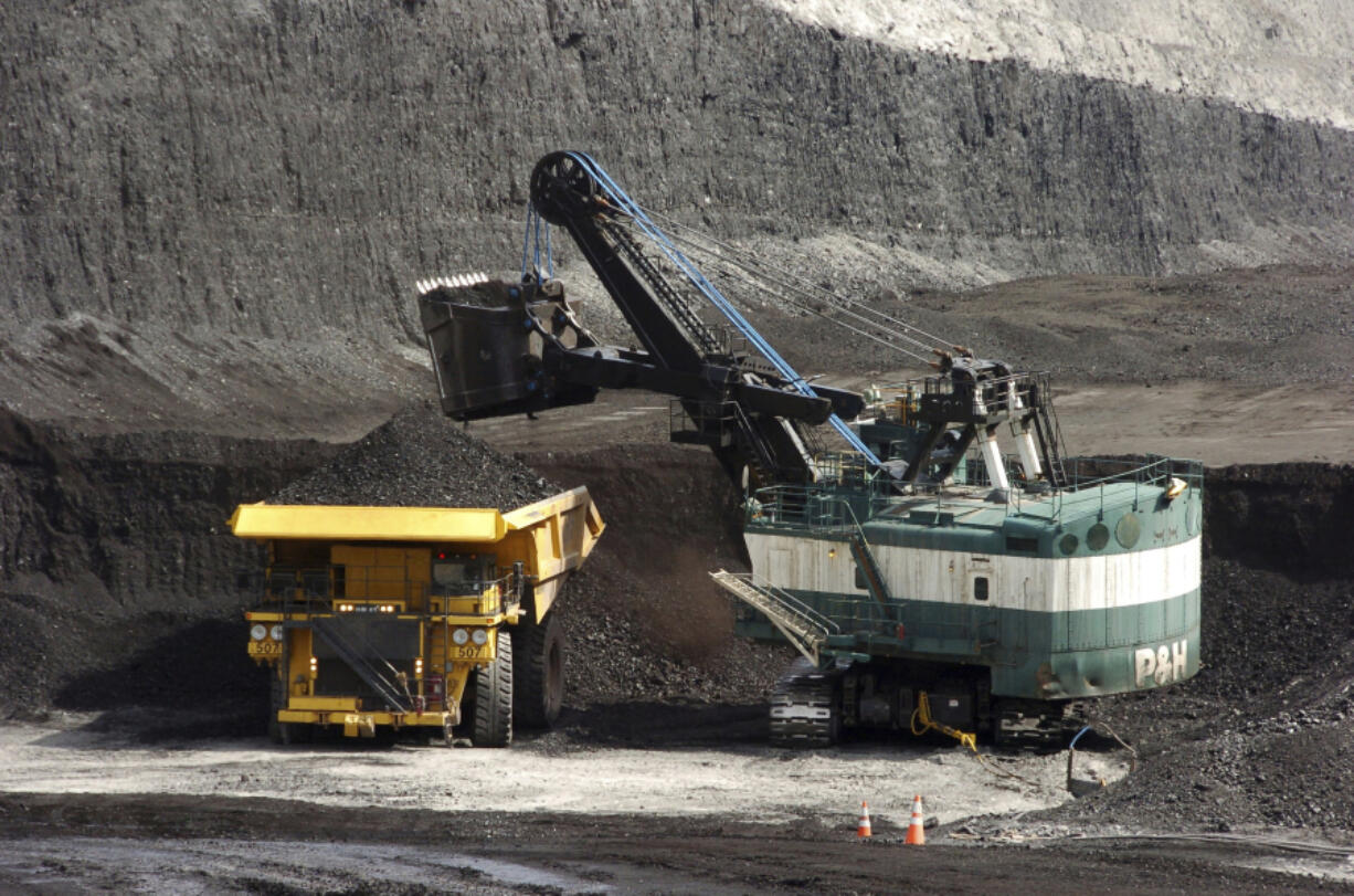 FILE - A mechanized shovel loads a haul truck that can carry up to 250 tons of coal at the Spring Creek coal mine, April 4, 2013, near Decker, Mont. On Wednesday, Feb. 21, 2024, a U.S. appeals court struck down a judge&rsquo;s 2022 order that imposed a moratorium on coal leasing from federal lands.