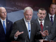 Sen. Ron Johnson, R-Wis., center, is joined by fellow Republicans, from left, Sen. Rick Scott, R-Fla., Sen. Ted Cruz, R-Texas, and Sen. Eric Schmitt, R-Mo., as they criticize the border security bill being negotiated, during a news conference at the Capitol in Washington, Wednesday, Jan. 24, 2024. (AP Photo/J.