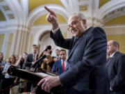 Senate Majority Leader Chuck Schumer, D-N.Y., answers questions on the border security talks as he meets reporters following a Democratic caucus meeting, at the Capitol in Washington, Wednesday, Jan. 31, 2024. (AP Photo/J.