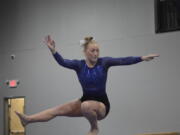 Hockinson's Celia Racanelli works the balance beam during Saturday's 3A/2A district gymnastics meet at Naydenov Gymnastics. Racanelli won the all-around Saturday to qualify for state.