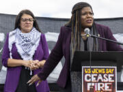 FILE - Rep. Cori Bush, D-Mo., speaks as Rep. Rashida Tlaib, D-Mich., listens during a demonstration calling for a ceasefire in Gaza near the Capitol in Washington, Oct. 18, 2023. A group of progressive lawmakers are fighting back against a multi-million dollar campaign to push them out of Congress for their vocal opposition to Israel&rsquo;s deadly bombardment of Gaza after the Oct. 7 attack.