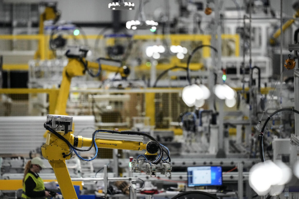 FILE - Articulated robots move inside the Hanwha Qcells Solar plant, Oct. 16, 2023, in Dalton, Ga. On Wednesday, Feb. 28, 2024, the government issues the second of three estimates of GDP growth in the United States during the October-December quarter.