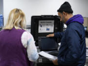 FILE - Election judges demonstrate the accuracy of the city&rsquo;s voting equipment on Oct. 28, 2022, in Minneapolis. With election season already underway, state election officials are expressing frustration that Congress has so far failed to allocate federal money they typically use for such things as securing voter registration systems, updating equipment and training staff.