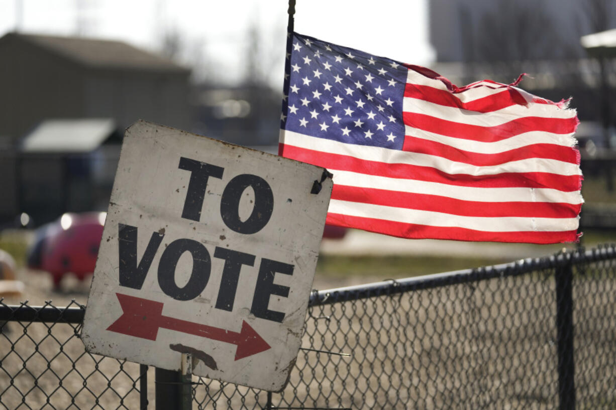 A vote sign and American flag are shown outside a Michigan primary election location in Dearborn, Mich., Tuesday, Feb. 27, 2024. Michigan is the last major primary state before Super Tuesday and a critical swing state in November&rsquo;s general election.