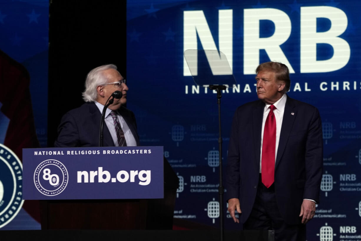Republican presidential candidate former President Donald Trump listens as David Friedman speaks at the National Religious Broadcasters convention at the Gaylord Opryland Resort and Convention Center Thursday, Feb. 22, 2024, in Nashville, Tenn.