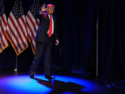 Republican presidential candidate former President Donald Trump waves after speaking at a caucus night rally in Las Vegas, Thursday, Feb. 8, 2024.