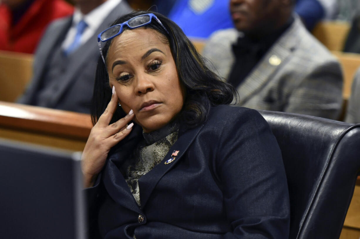 FILE - Fulton County District Attorney Fani Willis appears during a hearing regarding defendant Harrison Floyd, a leader in the organization Black Voices for Trump, as part of the Georgia election indictments, Nov. 21, 2023, in Atlanta. Lawyer Ashleigh Merchant, who has alleged that Willis has had an inappropriate romantic relationship with Nathan Wade, a special prosecutor hired for the Georgia election interference case against former President Donald Trump, has called the two to testify at a hearing next month.