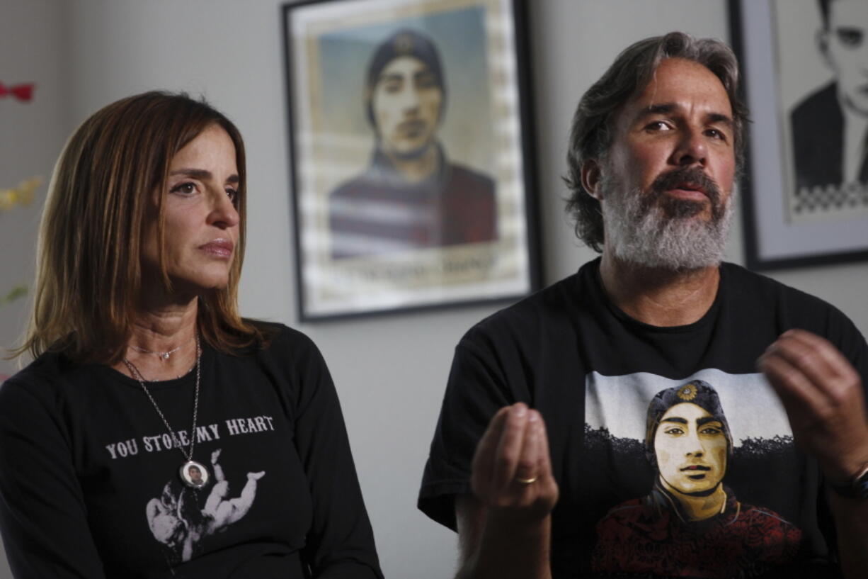 Manuel and Patricia Oliver, the parents of Joaquin Oliver, one of the victims of the 2018 mass shooting at Marjory Stoneman Douglas High School in Parkland, Fla., sit for an interview in Coral Springs, Fla., on Friday Feb. 9, 2024. The Olivers are launching a campaign where re-created voices of gun violence victims will call federal lawmakers. The recordings re-creating voices of victims from around the country are being robocalled to U.S. senators and House members who oppose stricter gun laws.