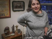 Anne D&rsquo;Innocenzio shows a family album surrounded by momentos from her childhood home Monday in New York. &ldquo;Clearing out Mom&rsquo;s house helped me fully appreciate her passion for a life full of family, art, books and travel,&rdquo; D&rsquo;Innocenzio said.