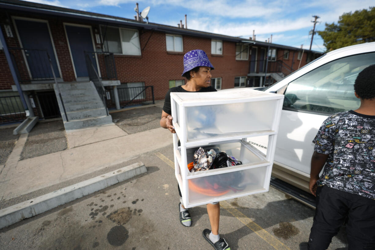 Monique Gant moves belongings out of an apartment after being evicted, Wednesday, Jan. 31, 2024, in Westminster, Colo. Monthly rent has outpaced income across the U.S., and forced many to make tough decisions between everyday necessities and a home. In turn, a record number of people are becoming homeless and evictions filings have ratcheted up as pandemic-era eviction moratoriums and federal assistance ends.