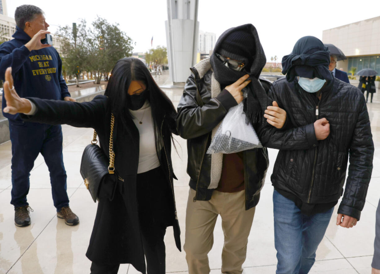 FILE - Alexander Smirnov, second from right, leaves the courthouse on Feb. 20, 2024, in Las Vegas. Smirnov, a former FBI informant charged with lying about a multimillion-dollar bribery scheme involving President Joe Biden&rsquo;s family, will appear in a California federal court on Monday, Feb. 26, as a judge considers whether he must remain behind bars while he awaits trial. Special counsel David Weiss&rsquo; office is pressing Judge Otis Wright II to keep Smirnov in jail, arguing the man who claims to have ties to Russian intelligence is likely to flee the country.