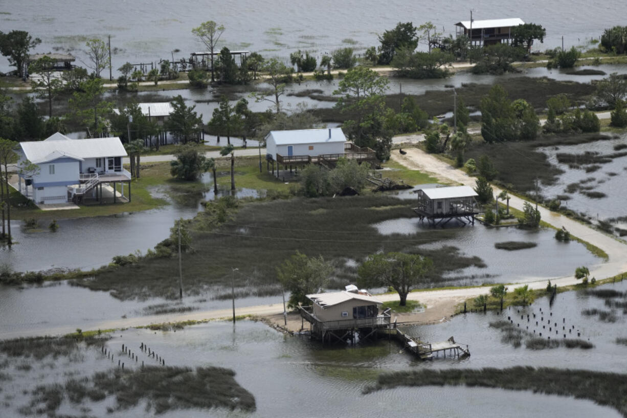 FILE - In this photo made in a flight provided by mediccorps.org, receding storm waters surround homes in Keaton Beach, Fla., following the passage of Hurricane Idalia, Wednesday, Aug. 30, 2023. A handful of powerful tropical storms in the last decade and the prospect of more to come has some experts proposing a new category of hurricanes: Category 6, which would be for storms with wind speeds of 192 miles per hour or more.