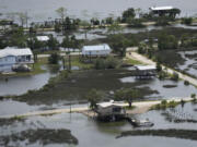 FILE - In this photo made in a flight provided by mediccorps.org, receding storm waters surround homes in Keaton Beach, Fla., following the passage of Hurricane Idalia, Wednesday, Aug. 30, 2023. A handful of powerful tropical storms in the last decade and the prospect of more to come has some experts proposing a new category of hurricanes: Category 6, which would be for storms with wind speeds of 192 miles per hour or more.