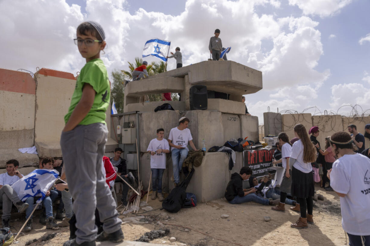 People gather at Israel&rsquo;s Nitzana border crossing with Egypt in southern Israel, Tuesday, Feb. 27, 2024, protesting against the delivery of humanitarian aid to the Gaza Strip until all hostages held by Hamas militants are released. Israel inspects international aid bound for Gaza before it is delivered into the territory.