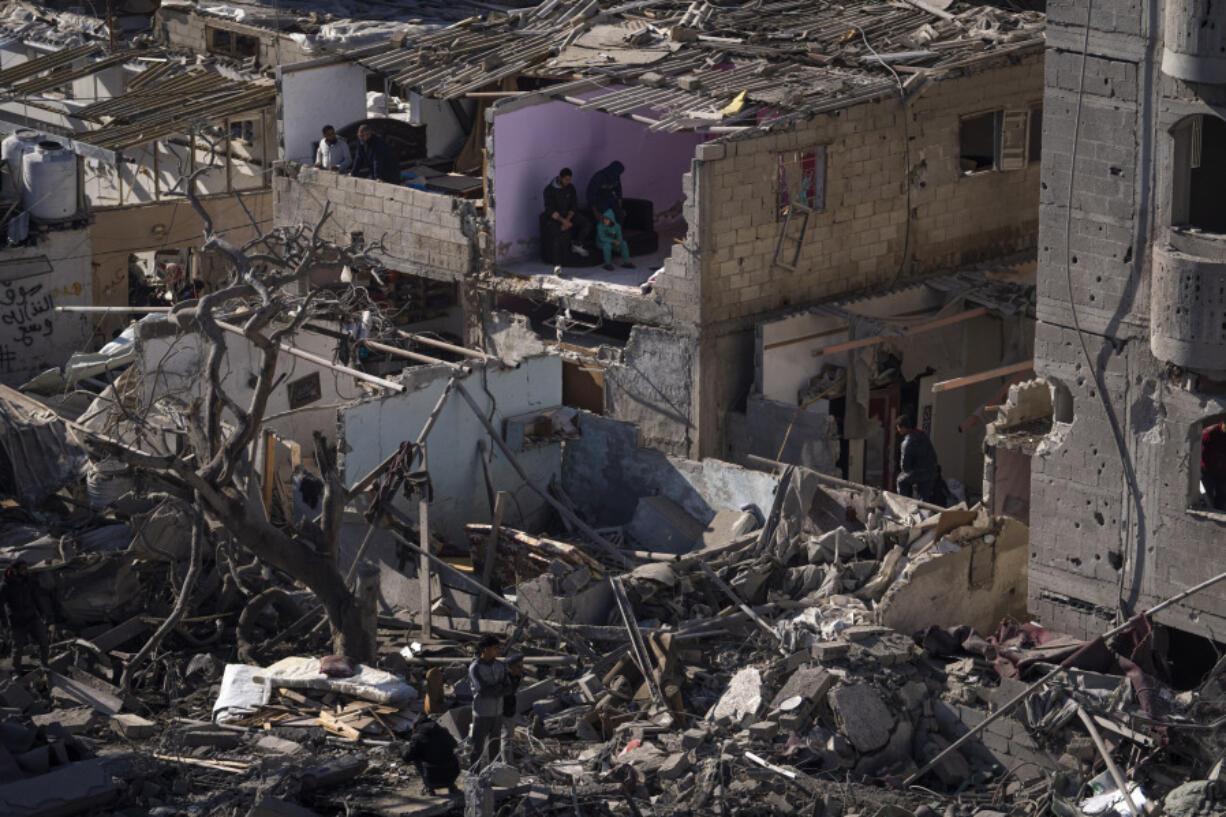 FILE - Palestinians look at the destruction after an Israeli strike on residential buildings and a mosque in Rafah, Gaza Strip, Thursday, Feb. 22, 2024. Israel and Hamas are inching toward a new deal that would free some of the roughly 130 hostages held in the Gaza Strip in exchange for a weeks-long pause in the war, now in its fifth month. A deal would bring some respite to desperate people in Gaza, who have borne a staggering toll in the war, as well as to the anguished families of hostages taken during Hamas&rsquo; Oct. 7 attack that sparked the war.