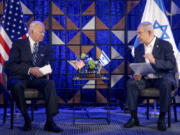 FILE - U.S. President Joe Biden, left, meets with Israeli Prime Minister Benjamin Netanyahu, right, to discuss the the war between Israel and Hamas, in Tel Aviv, Israel, on Oct. 18, 2023. U.S. and Mideast mediators appeared optimistic in recent days that they are closing in on a deal for a two-month cease-fire in Gaza and the release of over 100 hostages held by Hamas. But on Tuesday, Israeli Prime Minister Netanyahu rejected the militant group&rsquo;s two main demands &mdash; that Israel withdraw its forces from Gaza and release thousands of Palestinian prisoners &mdash; indicating that the gap between the two sides remains wide.