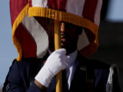 A US Airforce soldier holds the Stars and Stripes flag during a ceremony at the Sicily-Rome American Cemetery to commemorate the 80th Anniversary of the landing of allied forces on the shores of Anzio and Nettuno, in Nettuno, central Italy, Wednesday, Jan. 24, 2024.