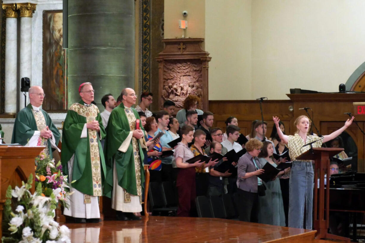 The Rev. James Martin, Archbishop John Wester of Santa Fe, N.M., left, and Rev. Eric Andrews attend the closing Mass on June 18 for the Outreach conference at the Church of St. Paul the Apostle, in New York. Martin is the founder of Outreach, a unique Jesuit-run program of outreach to LGBTQ+ Catholics.