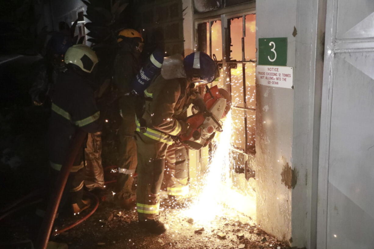 Firefighters put out the fire caused by a vehicle loaded with gas which exploded, in Nairobi, Kenya, Friday, Feb. 2, 2024. The truck explosion ignited a huge fireball, and a flying gas cylinder set off a fire that burned down the Oriental Godown, a warehouse that deals with garments and textiles, according to government spokesman Isaac Mwaura.