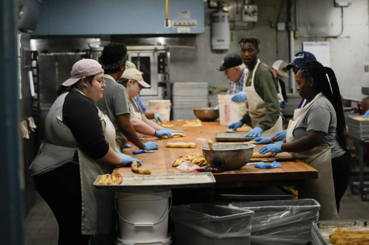 Workers roll dough as they make king cakes at Haydel&rsquo;s Bakery in Jefferson Parish, La., on Wednesday.