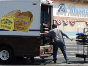 FILE - Mitch Maddox, a bread route salesman, loads bread Tuesday, May 30, 2006, outside the Eagle Rock Albertsons store in Los Angeles. The Federal Trade Commission on Monday, Feb.