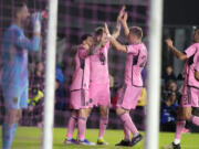 Inter Miami midfielder Robert Taylor, center, celebrates with teammates, including Lionel Messi, left, after his goal agianst Real Salt Lake during the first half of an MLS soccer match Wednesday, Feb. 21, 2024, in Fort Lauderdale, Fla.