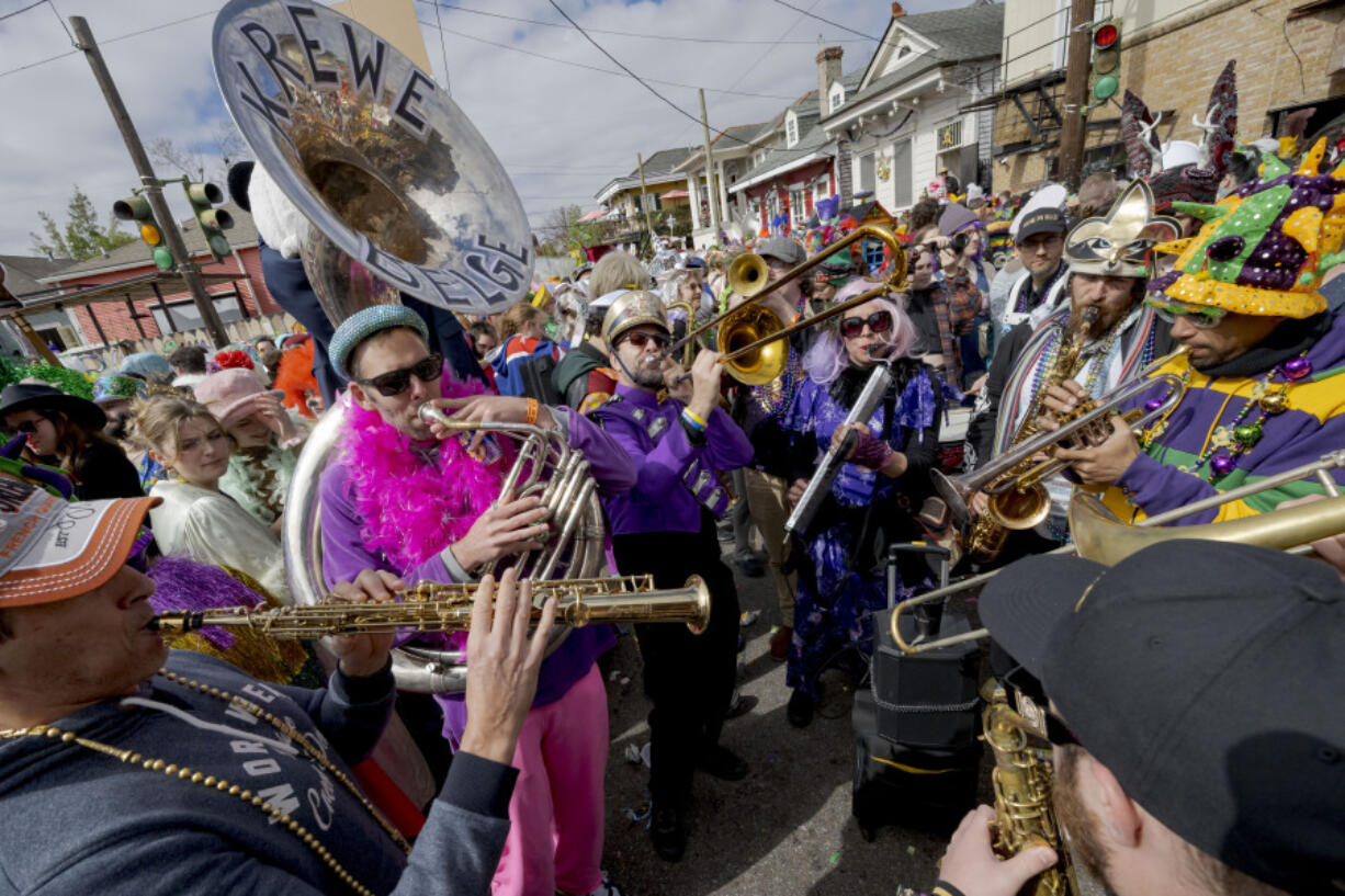 The Krewe du Belge plays during the Society of Saint Anne parade through Bywater and Marigny neighborhoods on Mardi Gras Day in New Orleans, Tuesday, Feb. 13, 2024.