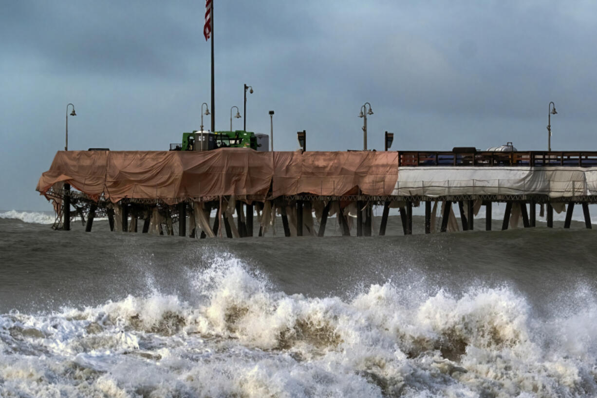 Large waves crash along the Southern California coast near the Ventura Pier in Ventura, Calif., on Dec. 30. Since the Gold Rush, California&rsquo;s coast has been dotted by piers that have gone from serving steamships to becoming an integral part of many beach towns&rsquo; identities, but rising seas and frequent storms due in part to climate change are threatening the iconic structures.