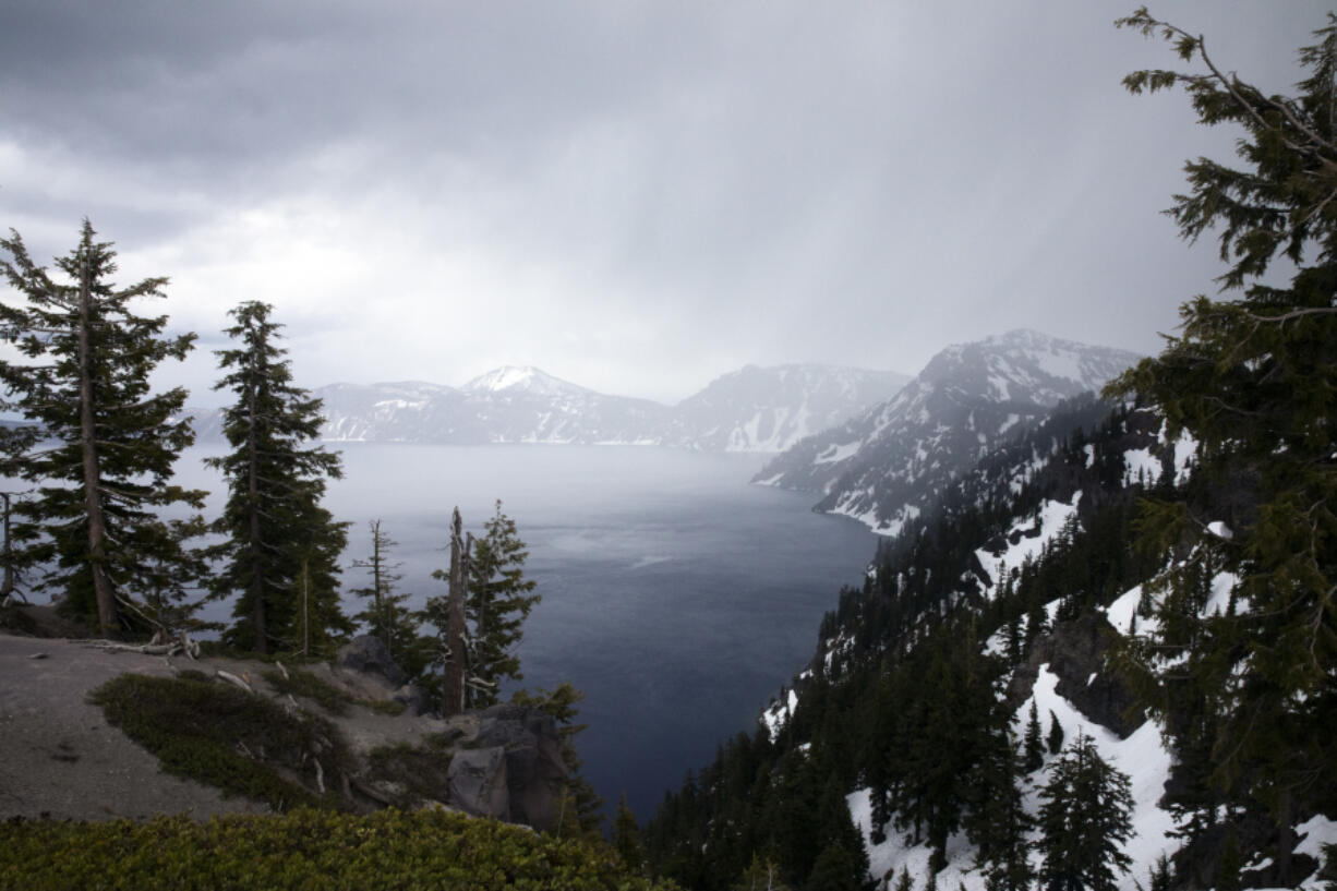 Rain falls over Crater Lake on June 1, 2023, in Crater Lake, Ore.