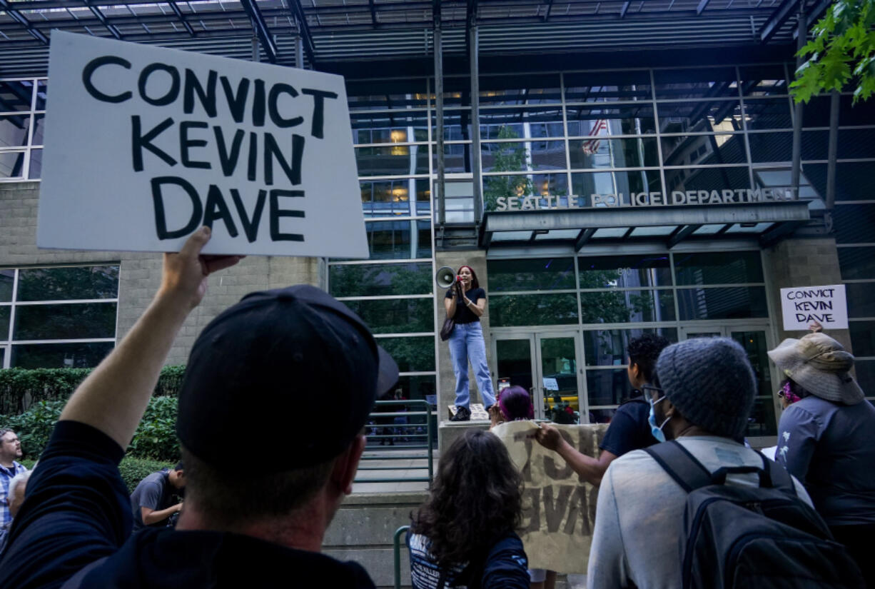 FILE - Kyla Carrillo, center, leads a chant on the steps of the Seattle Police Department&#039;s West Precinct as people protest after body camera footage was released of a Seattle police officer joking about the death of Jaahnavi Kandula, a 23-year-old woman hit and killed in January by officer Kevin Dave in a police cruiser, Thursday, Sept. 14, 2023, in Seattle. Prosecutors in Washington state said Wednesday, Feb. 21, 2024, they will not file felony charges against Seattle police officer, Dave, who struck and killed the graduate student from India while responding to an overdose call..