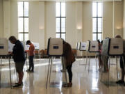 FILE - People vote on Election Day, Nov. 7, 2023, at Knox Presbyterian Church in Cincinnati. Ohio&rsquo;s Republican lawmakers are far from coasting through this election season despite wielding the power in both chambers of the state Legislature. The primaries in March 2024 will likely be used to wage a bitter power battle within their own party that could determine just how red the state runs. (AP Photo/Joshua A.