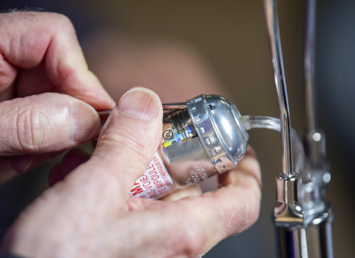 A Repair Clark County volunteer fixes a lamp during a 2022 event in Vancouver.