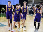 Columbia River players, from left, Miles Fitzwilson, Ari Richardson, Carter Sheron and John Reeder celebrate a 3-point basket by Richardson during a Class 2A boys basketball state playoff game against Anacortes on Wednesday, Feb. 28, 2024 in Yakima.