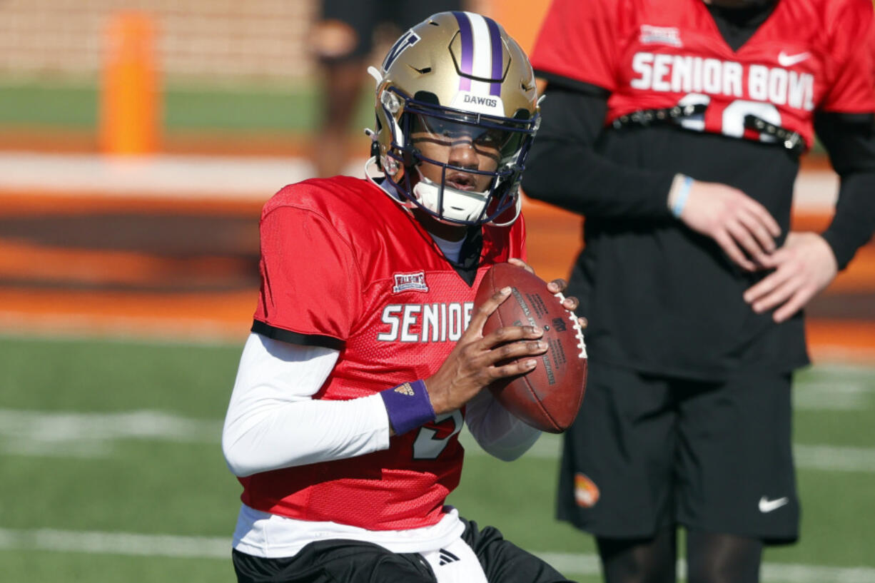 National quarterback Michael Penix Jr. of Washington runs through drills during practice for the Senior Bowl NCAA college football game, Tuesday, Jan. 30, 2024, in Mobile, Ala.