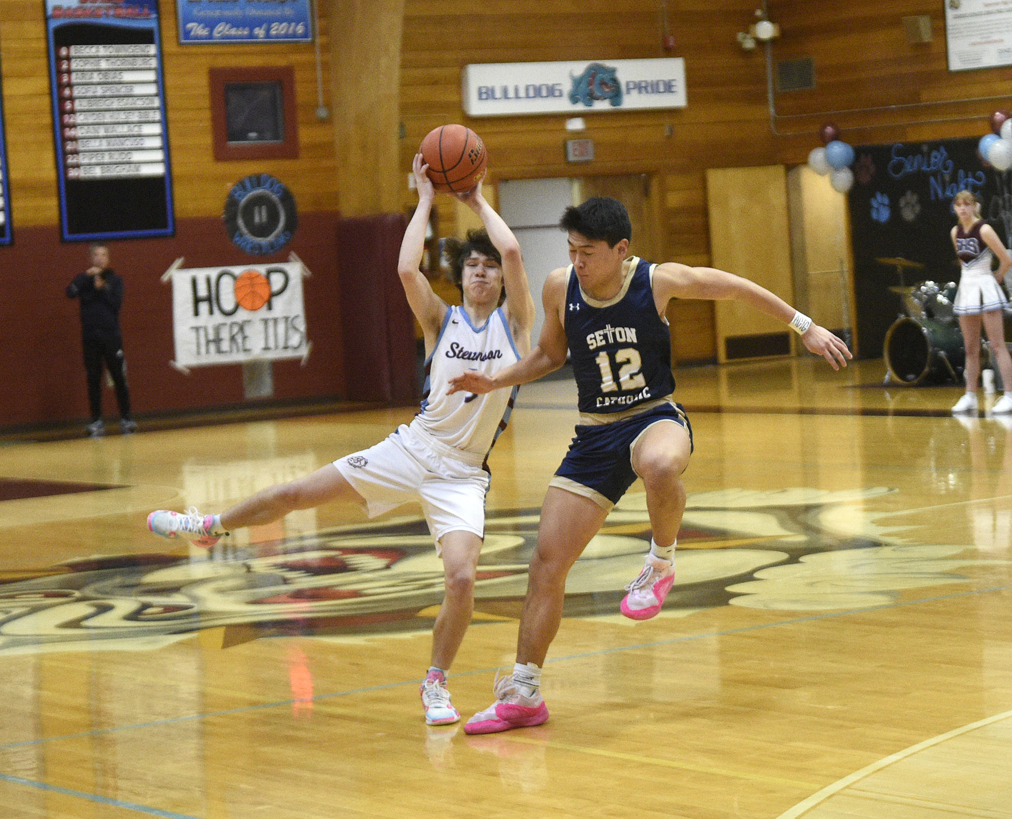 Chris Blackledge of Stevenson (left) catches a pass as Lance Lee (12) of Seton Catholic tries for a steal in a Trico League boys basketball game at Stevenson High School on Thursday, Feb. 1, 2024.