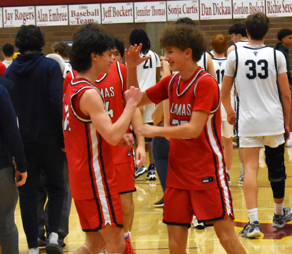 Camas freshman Carter Morgan (right) celebrates with junior Jace VanVoorhis after the Papermakers' 40-38 win over Skyview in a 4A Greater St. Helens League boys basketball tiebreaker game at Prairie High School on Wednesday, Feb. 7, 2024.