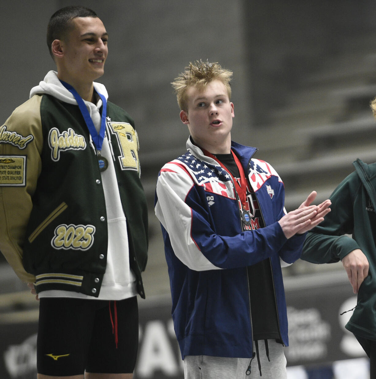 Owen Robertson of Union applauds for state champion Jaiden Sreenivasan (left) of Redmond after Robertson placed second in the 200 freestyle at the Class 4A boys swimming state championships at the King County Aquatic Center in Federal Way on Saturday, Feb. 17, 2024.