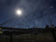 Concertina wire is stretched through Shelby Park where Texas Gov. Greg Abbott and fellow Governors held a news conference along the Rio Grande to discuss Operation Lone Star and border concerns, Sunday, Feb. 4, 2024, in Eagle Pass, Texas. Abbott returned to the Eagle Pass border to highlight his escalating attempts to curb illegal crossings on the U.S.-Mexico border.