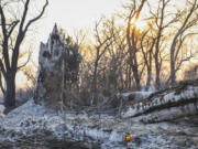 Charred tree trunks smolder after the Smokehouse Creek Fire burned through the area Wednesday, Feb. 28, 2024, in Canadian, Texas.