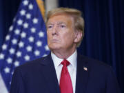 Former President Donald Trump speaks to the media at a Washington hotel, Tuesday, Jan. 9, 2024, after attending a hearing before the D.C. Circuit Court of Appeals at the federal courthouse in Washington.