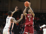 Washington State forward Jaylen Wells (0) shoots over Oregon State guard Christian Wright (1) during the second half of an NCAA college basketball game Thursday, Feb. 8, 2024, in Corvallis, Ore.