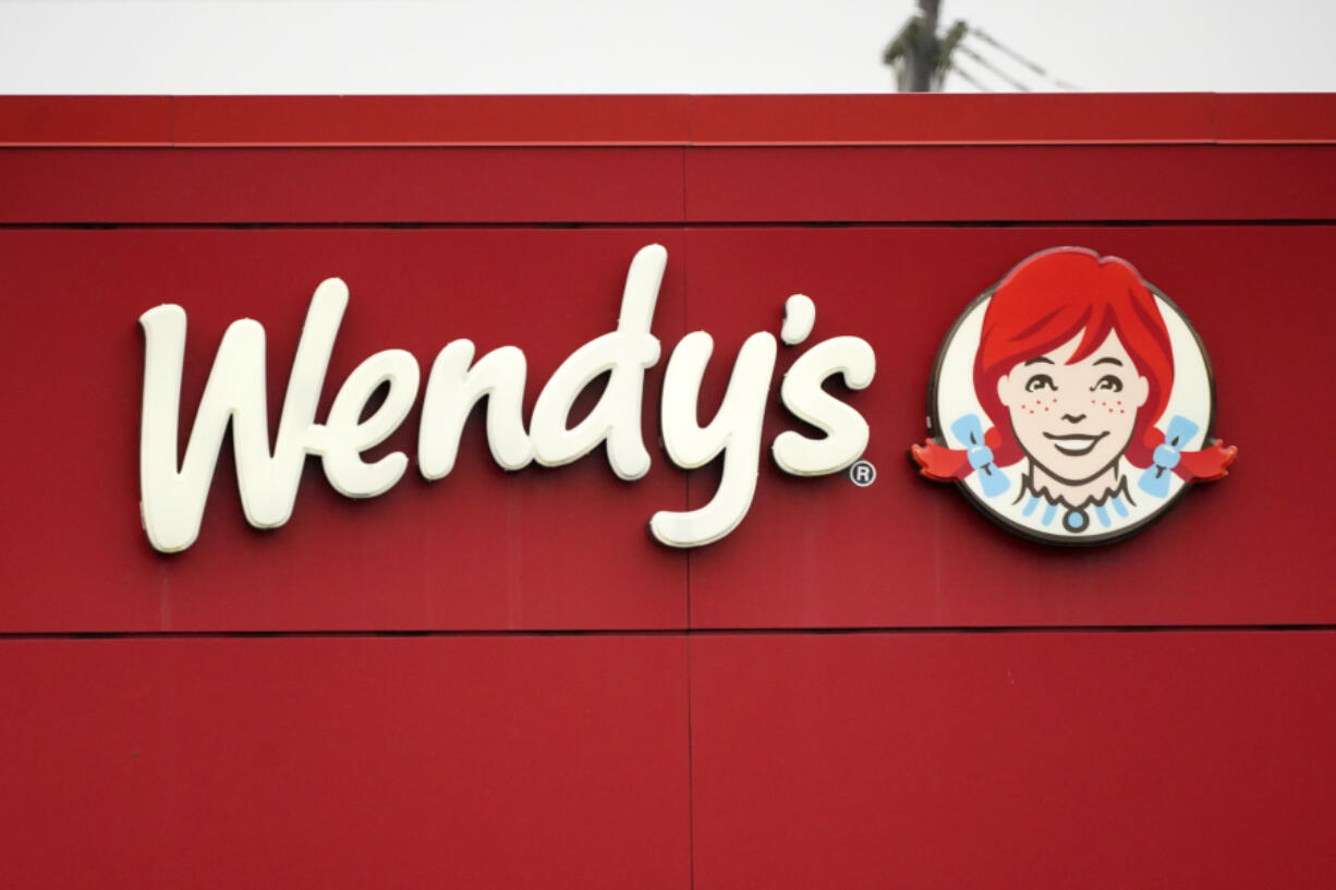 FILE - The Wendy&#039;s sign is seen at a restaurant, Jan. 23, 2023, in Pittsburgh. Wendy&#039;s is looking to test having the prices of its menu items fluctuate throughout the day based on demand, implementing a strategy that has already taken hold with ride-sharing companies and ticket sellers. (AP Photo/Gene J.