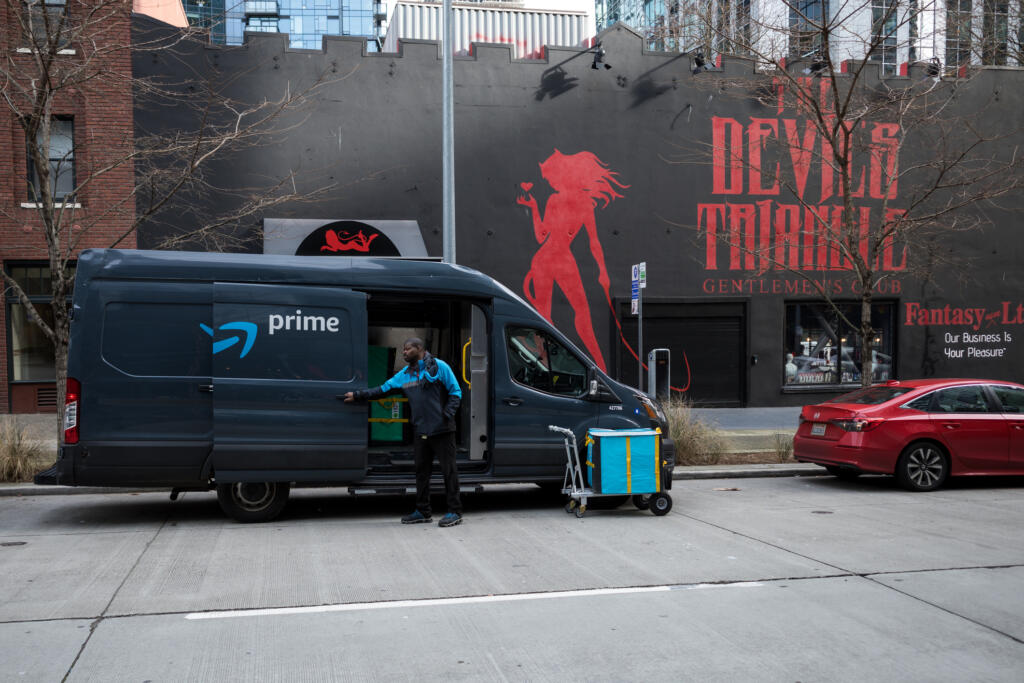 An Amazon prime delivery van parks Feb. 23, 2023, in front the Devil's Triangle near the Amazon Campus in South Lake Union, Seattle.