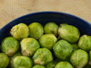 Preheat oven to 400 
 &deg;F. Remove stem end from Brussel sprouts and cut in half. Cut potatoes in half or into pieces about the same size as the Brussel sprouts. Line a baking sheet with foil. Add the oil and roll the potatoes and Brussel sprouts in the oil making sure all sides are covered. (Dorothy Merrimon Crawford/Dreamstime/TNS)