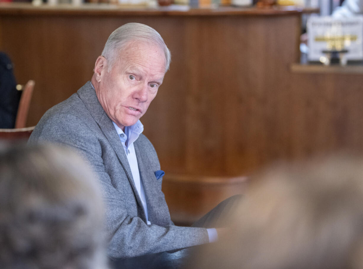 Washington State Rep. Paul Harris speaks to a table of people Thursday, Nov. 9, 2023, at Brewed Awakenings in northeast Vancouver. Harris and State Sen. Sen. Lynda Wilson met with constituents to hear their concerns while the legislature is not in session.