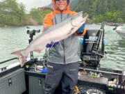 Fishing guide Chris Turvey with a spring Chinook taken in Drano Lake last year.