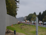 Traffic travels westbound on state Highway 14 while passing a nearly completed sound wall on Oct. 25, 2023.