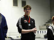 Tarik Kurta of Fort Vancouver stands on the podium after finishing second in the 50 freestyle at the 2A boys swimming state championship meet at the King County Aquatic Center in Federal Way on Saturday, Feb. 17, 2024.